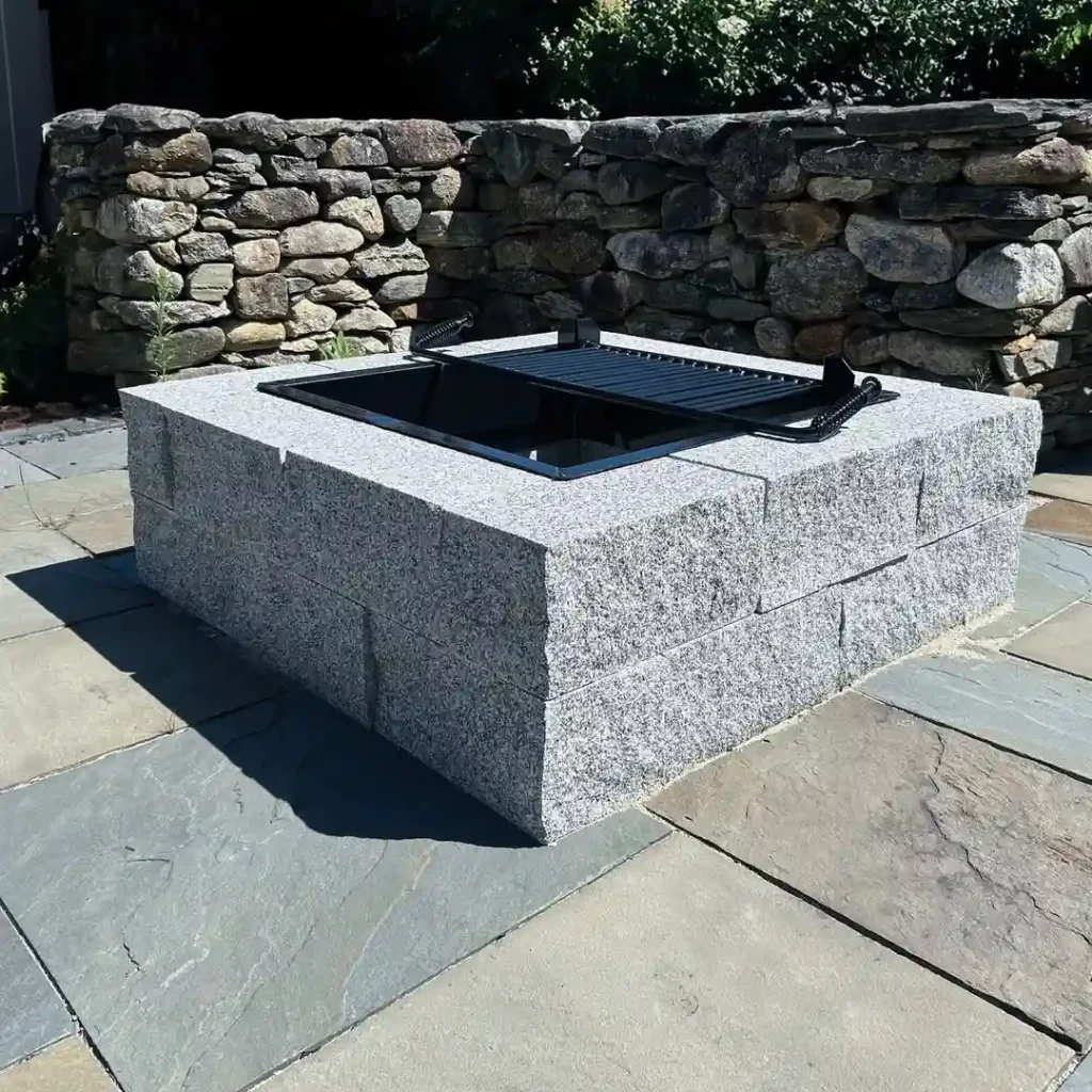 Sleek Modern Fire Pit with Stone Wall Backdrop